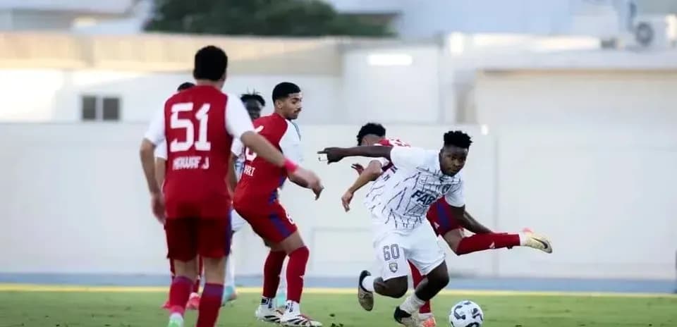 Player dribbling the ball during U23 football match