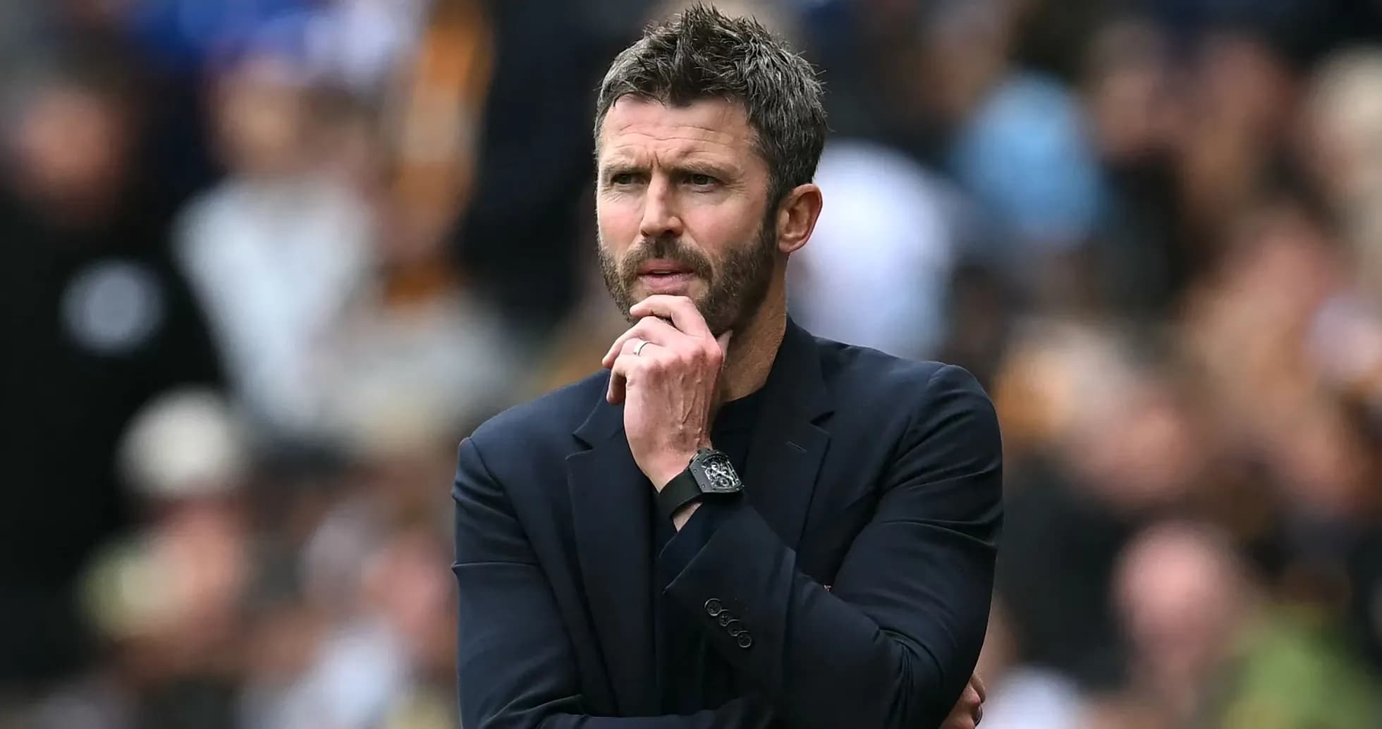 Manager contemplating during a match on the sideline
