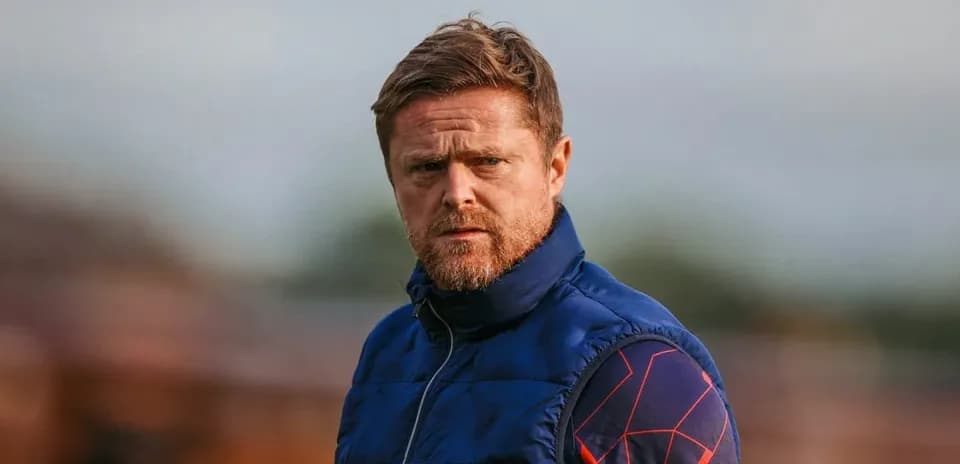 Coach observing players during training session