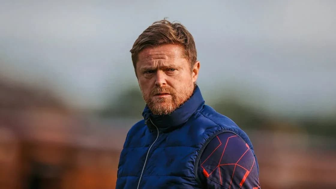 Coach observing players during training session