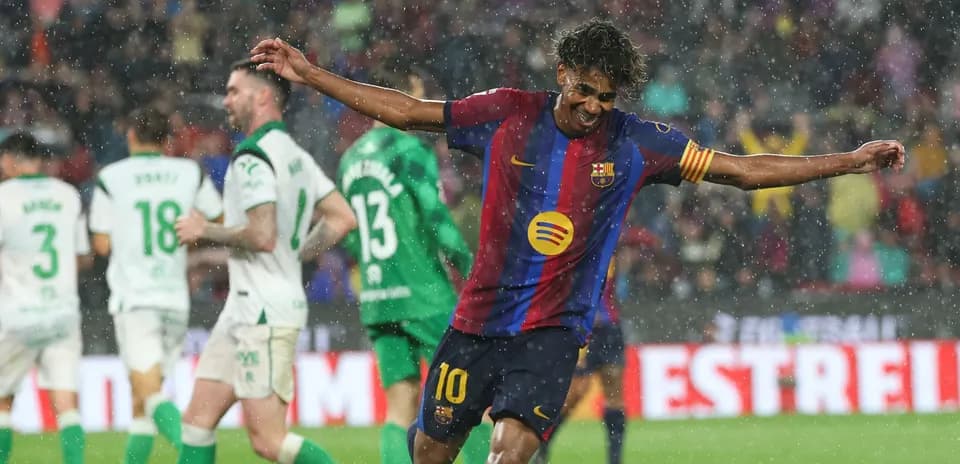 Barcelona player celebrating a goal in the rain