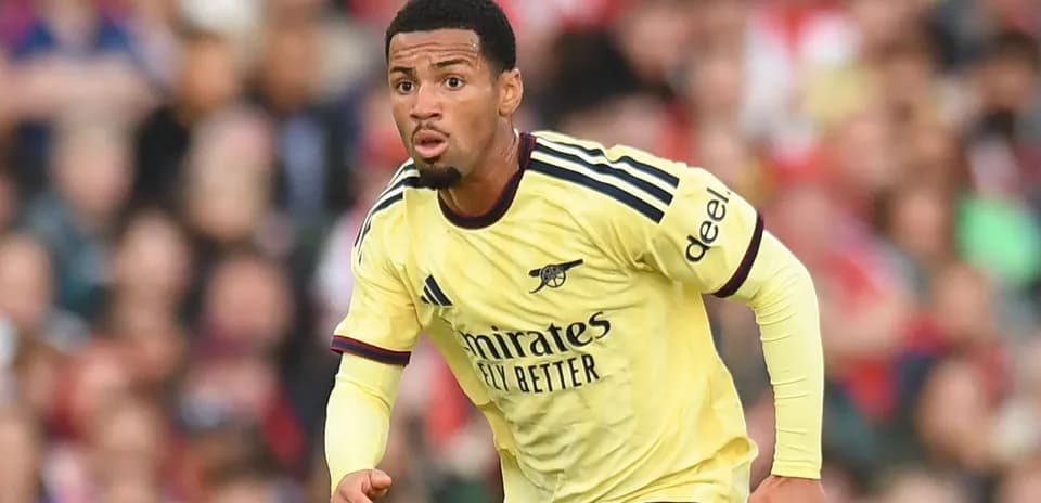 Player in Arsenal jersey running on the pitch