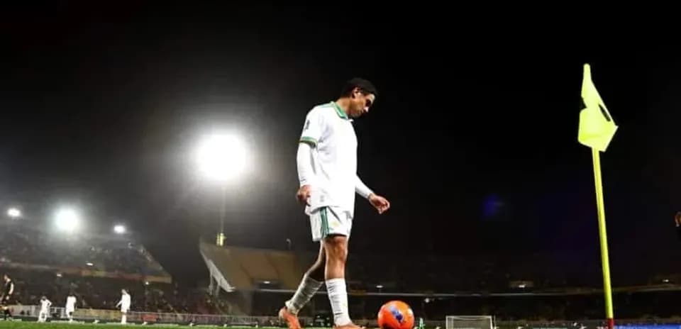 Player preparing to take corner kick at night