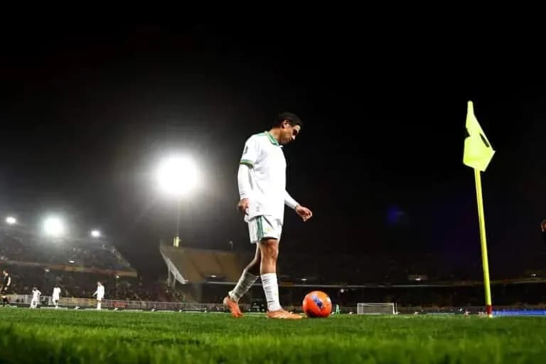 Player preparing to take corner kick at night