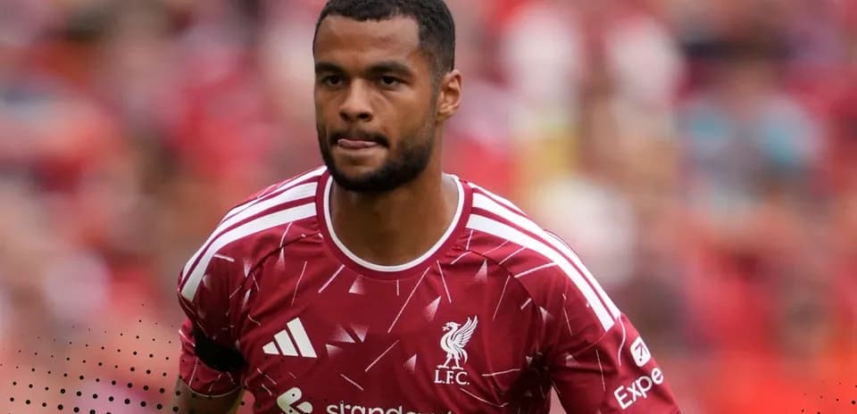 Player in Liverpool FC kit walking on the pitch
