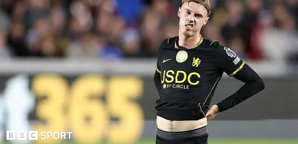 Player adjusting shirt during a football match