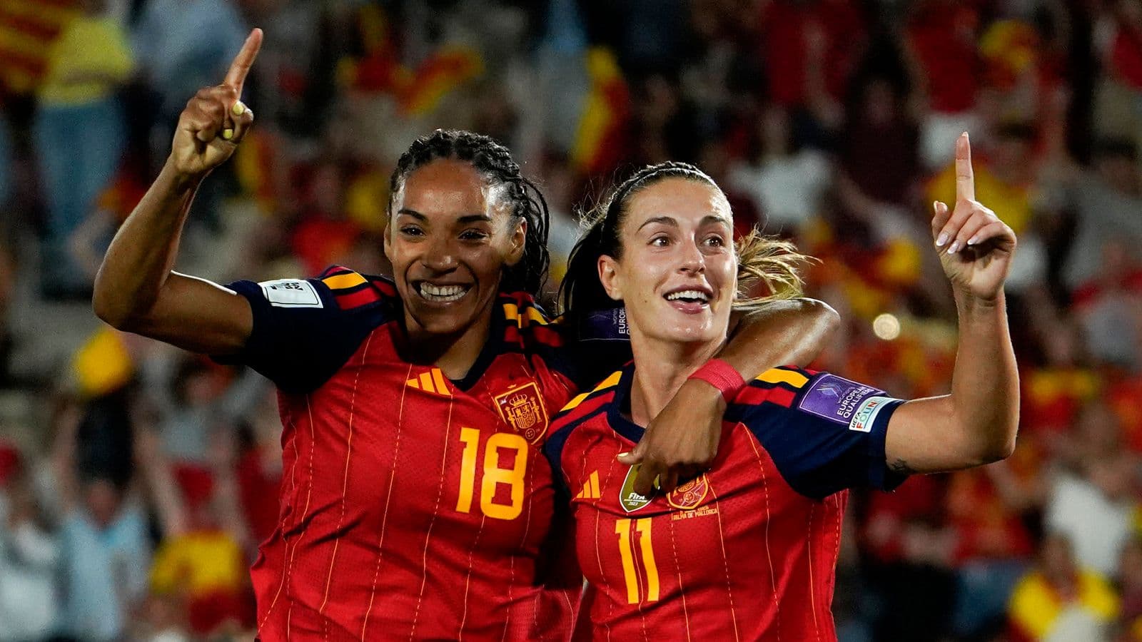 Two Spain players celebrating a goal together