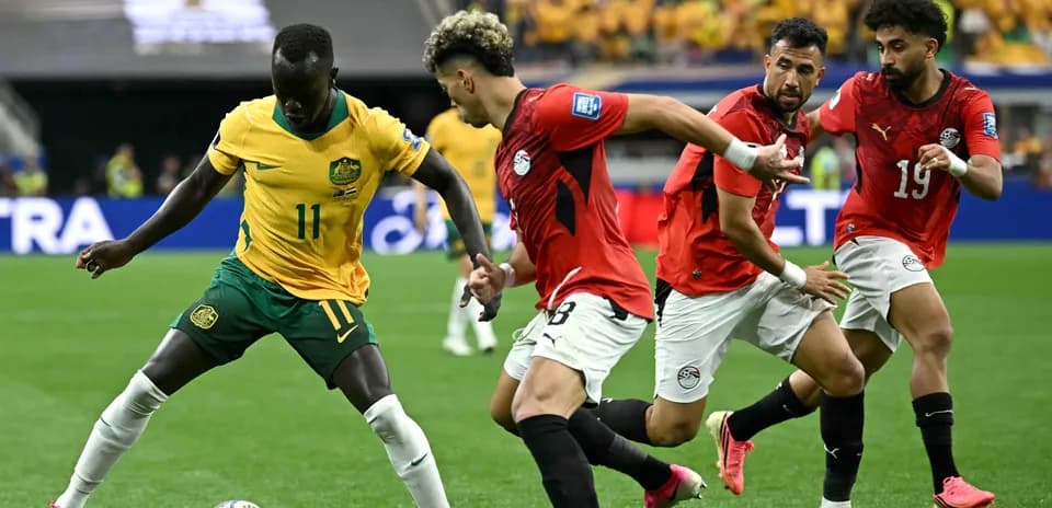 Player dribbling the ball surrounded by defenders
