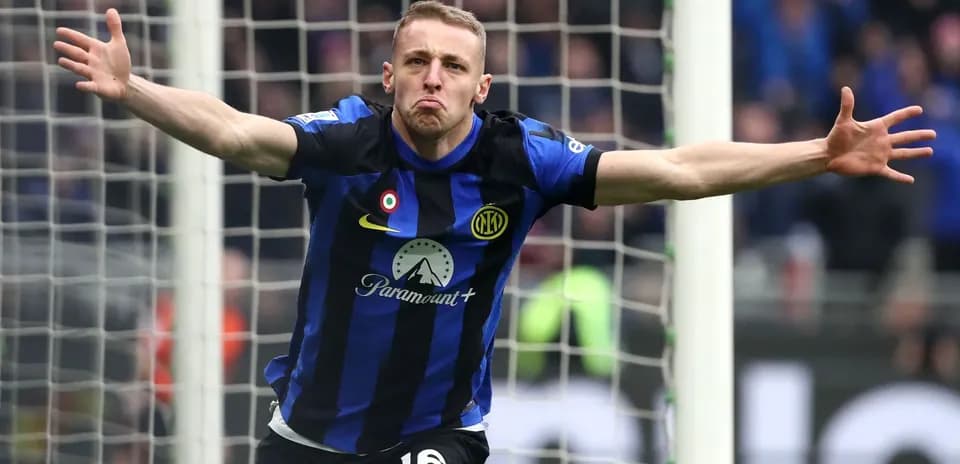 Player celebrating a goal in blue and black uniform