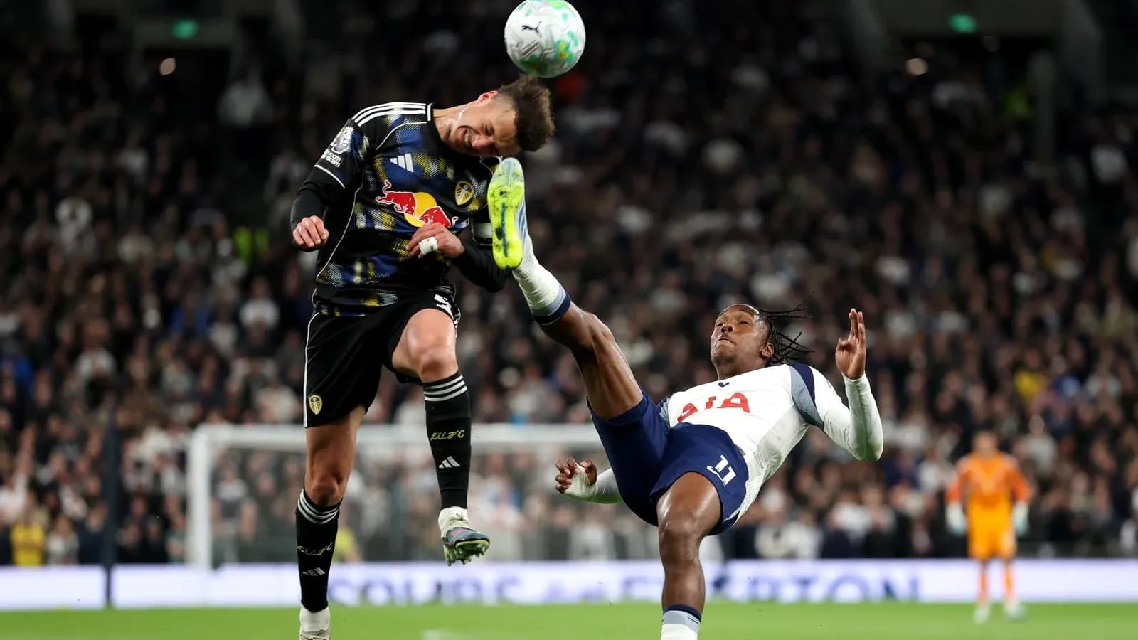 Goalkeeper and player collide during football match