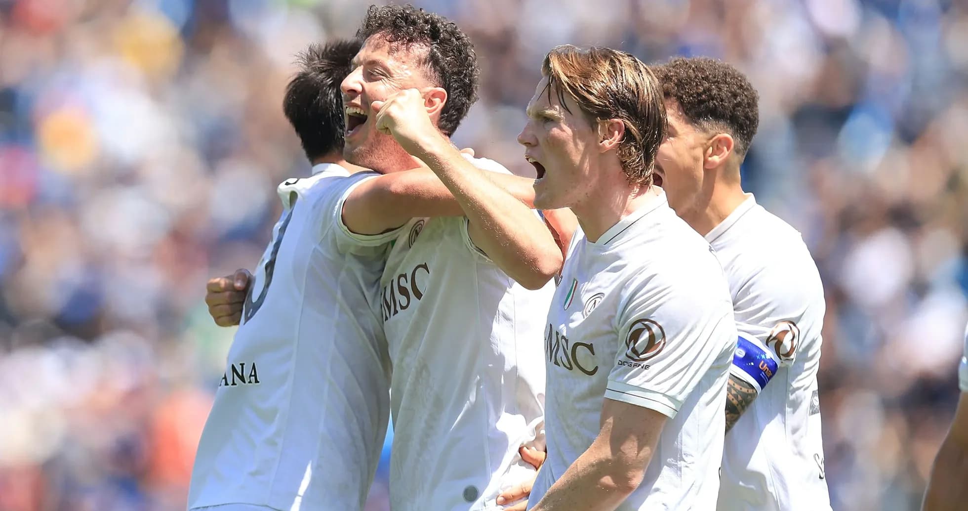 Players celebrating a goal on the field
