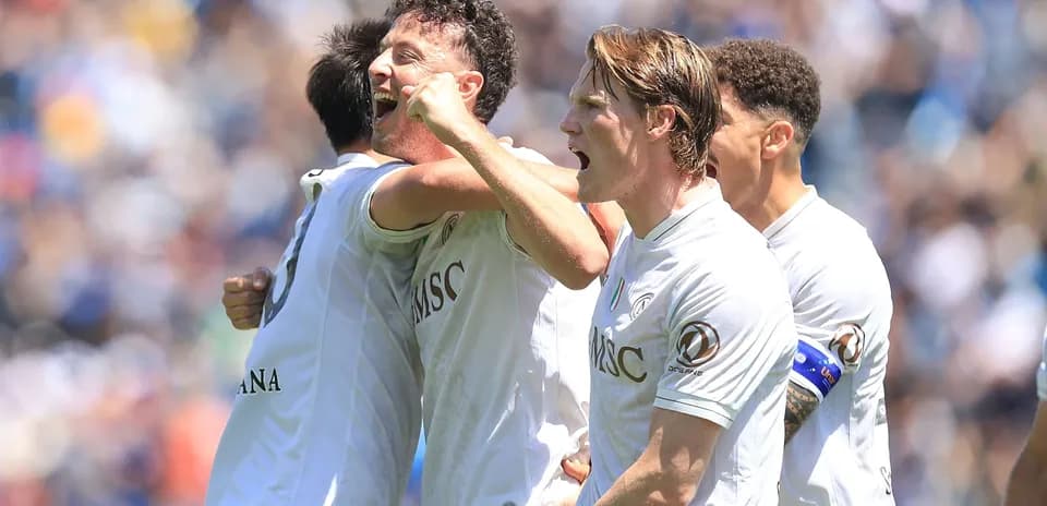 Players celebrating a goal on the field