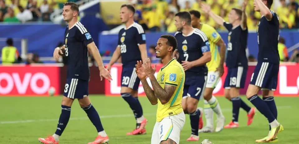 Brazilian player kneeling as Scottish team celebrates