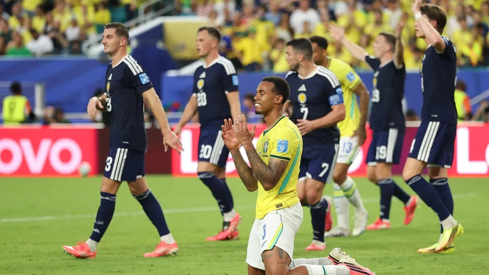 Brazilian player kneeling as Scottish team celebrates