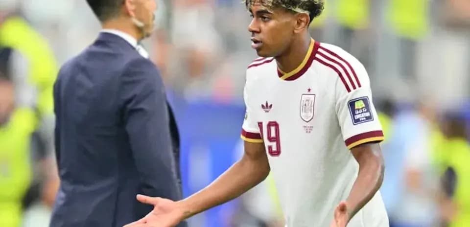 Player gesturing during match with coach nearby