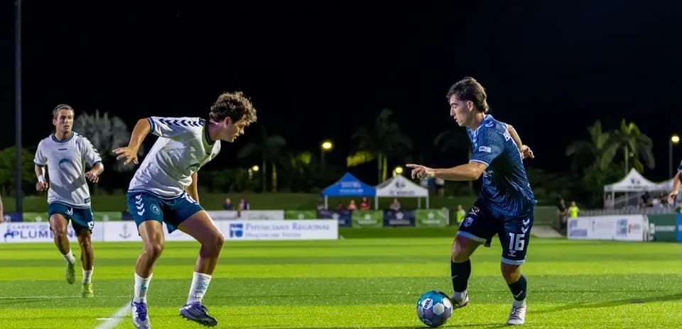 Player dribbling during Naples vs Sarasota match