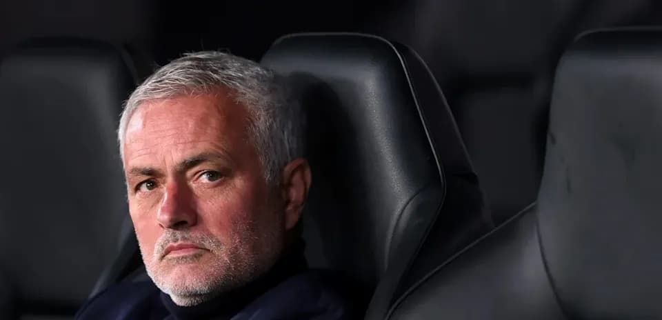 Manager seated on bench during match
