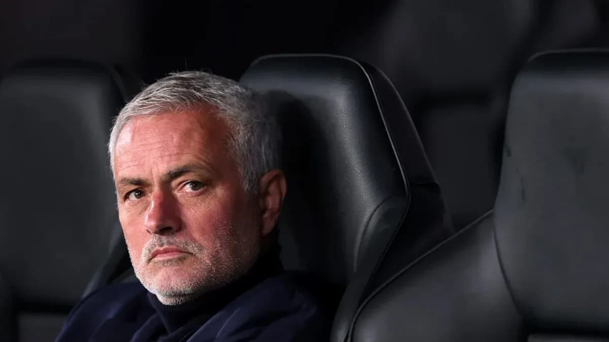Manager seated on bench during match