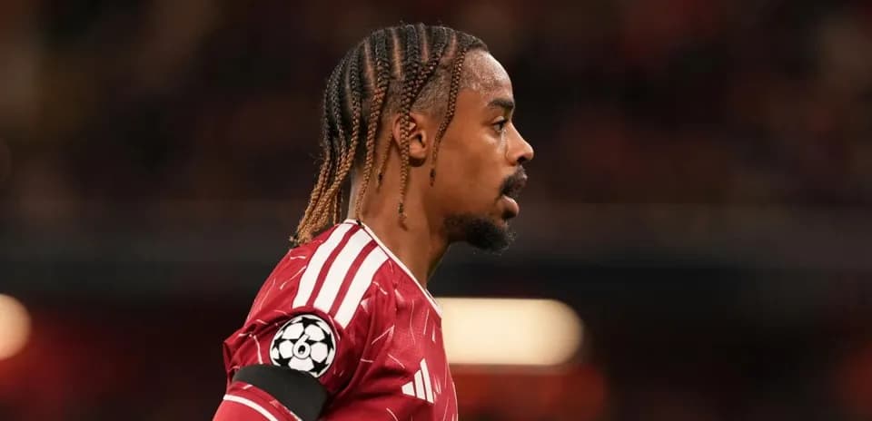 Player in red jersey with braided hair during match