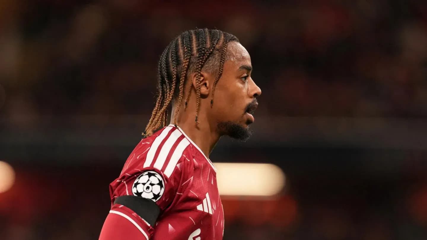 Player in red jersey with braided hair during match