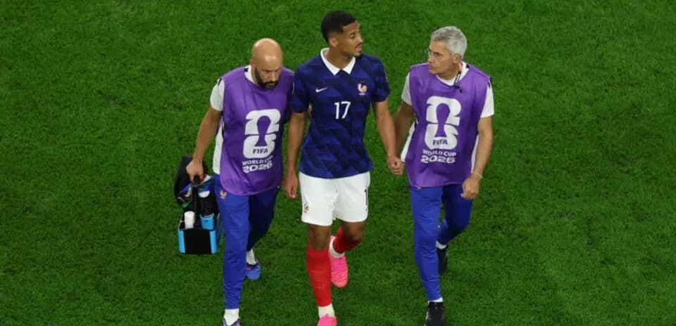 Player walking off field with medical staff assistance