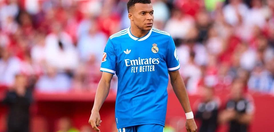 Player in blue Real Madrid kit on the pitch