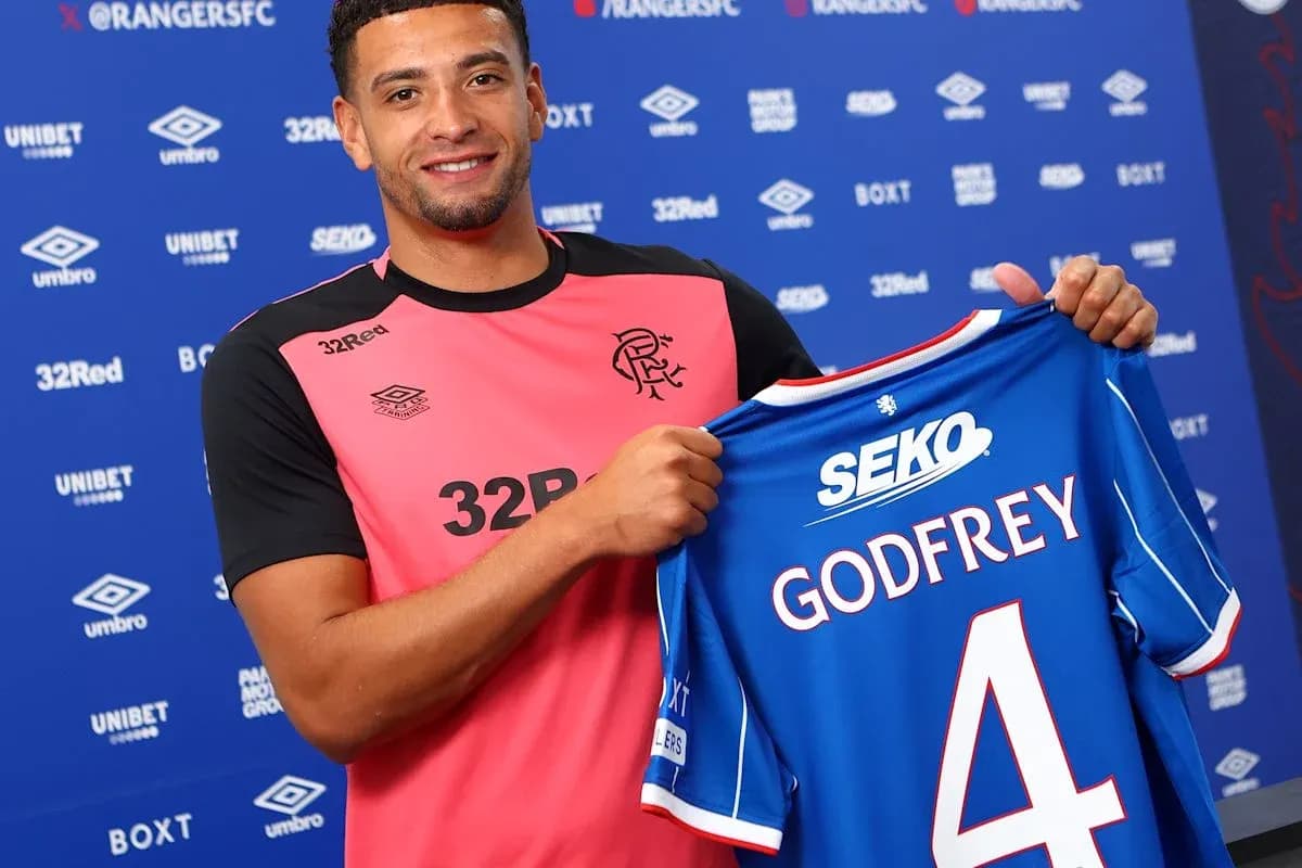 Player holding new jersey during signing event