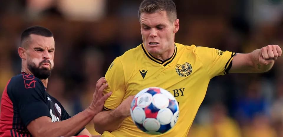 Mjallby player battling for ball during match