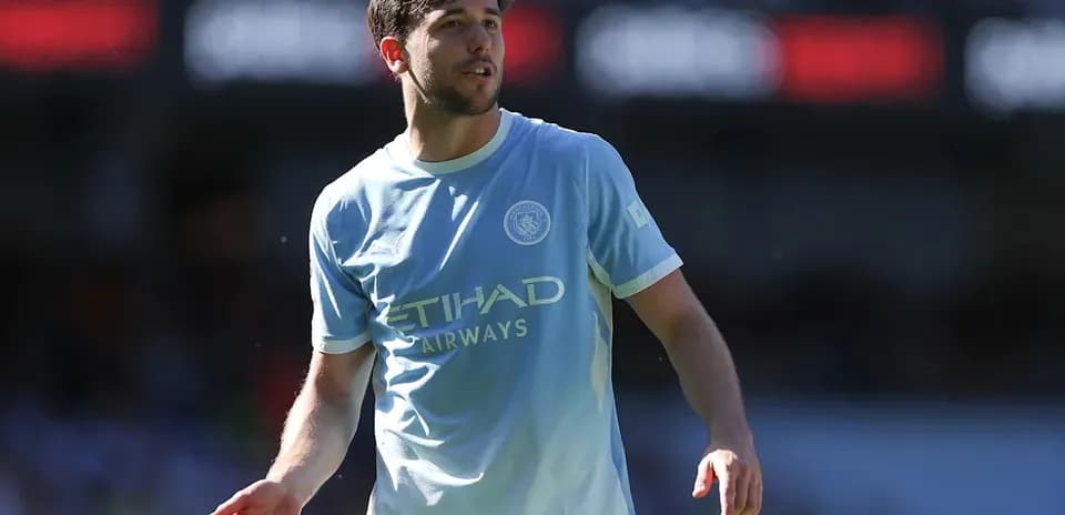 Player in light blue Manchester City kit on pitch