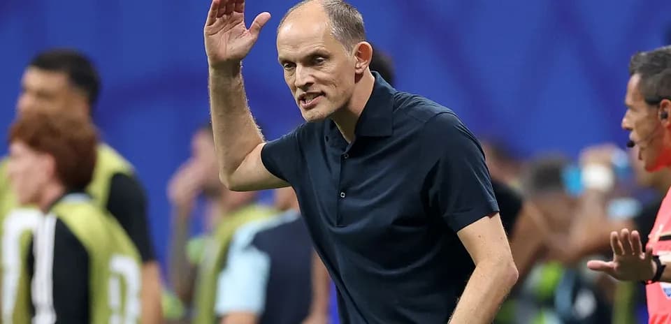 Coach gesturing during a football match on sidelines