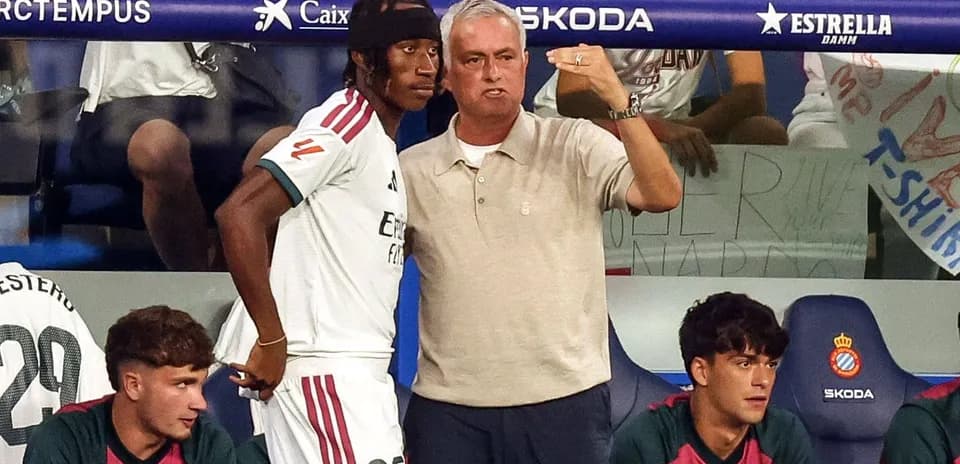 Coach instructing player on the sidelines during match