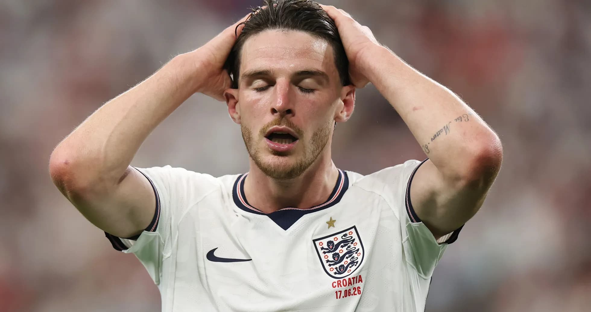 Player in England jersey holding head during match