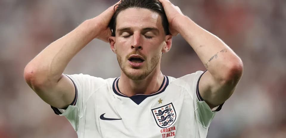 Player in England jersey holding head during match