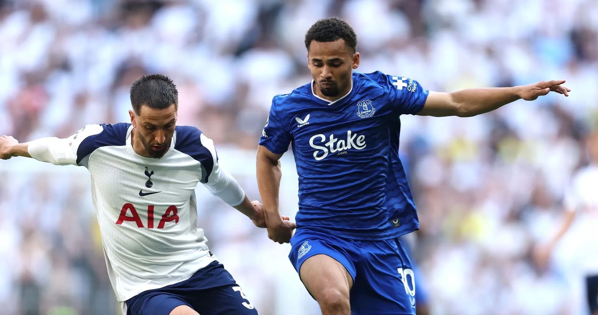 Tottenham and Everton players competing for possession