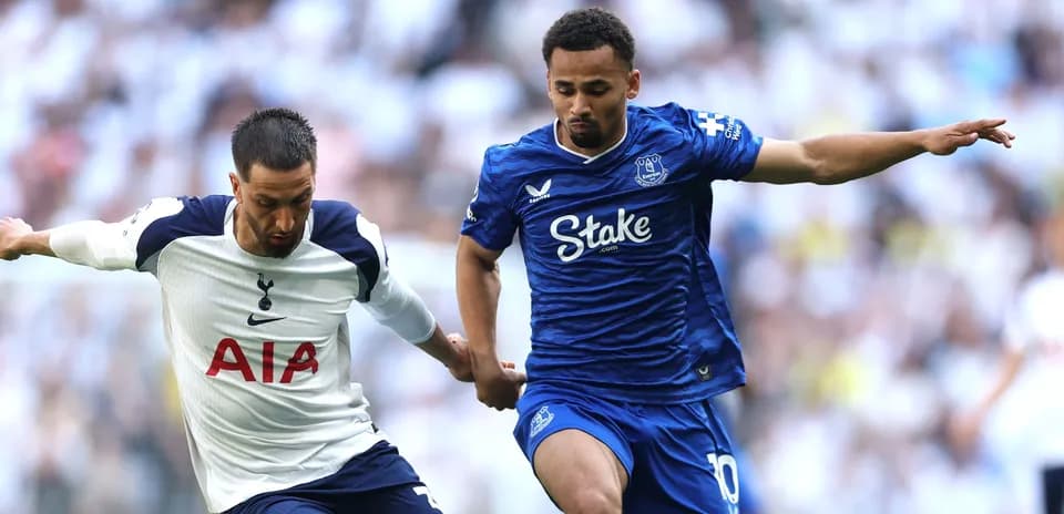 Tottenham and Everton players competing for possession