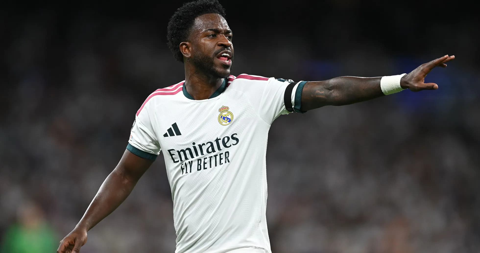Player gesturing during match wearing Real Madrid jersey