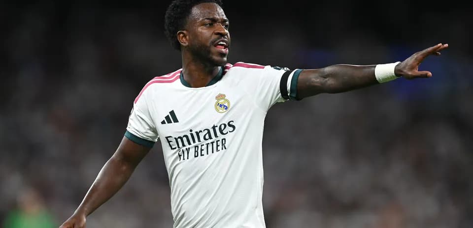 Player gesturing during match wearing Real Madrid jersey