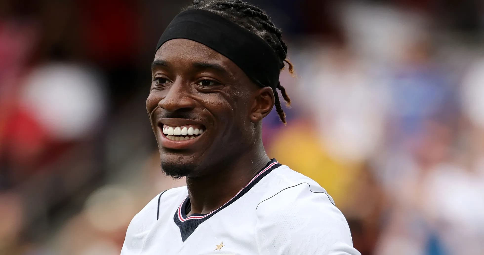 Player smiling during match warm-up on field