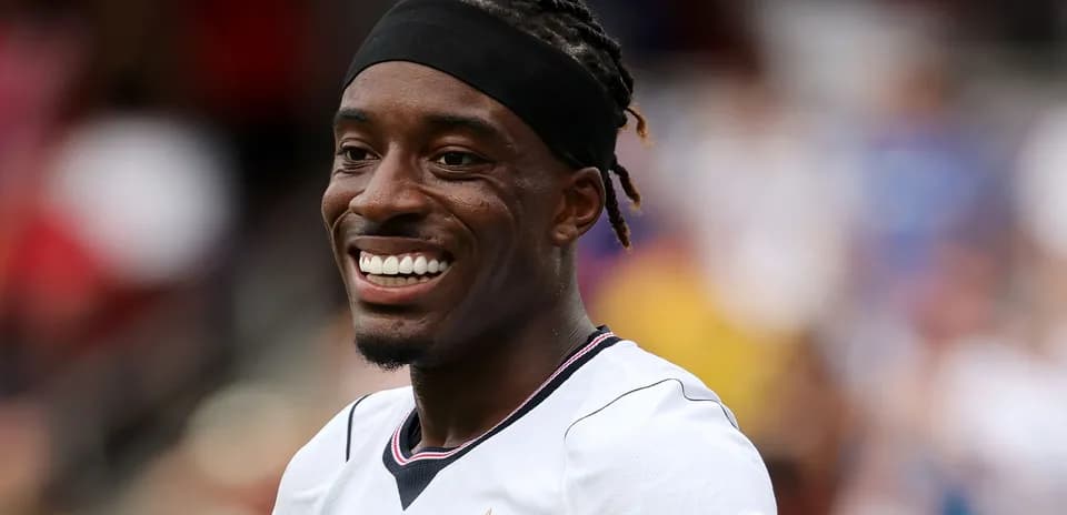 Player smiling during match warm-up on field