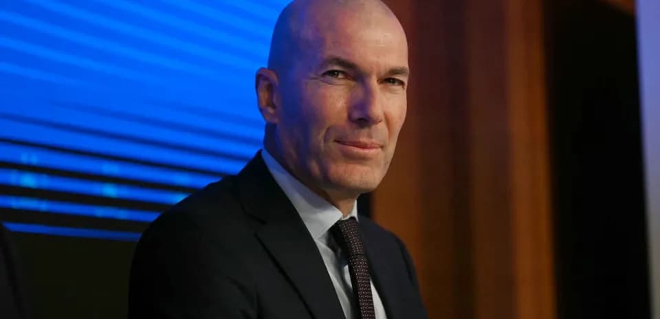 Man in suit sitting at a press conference