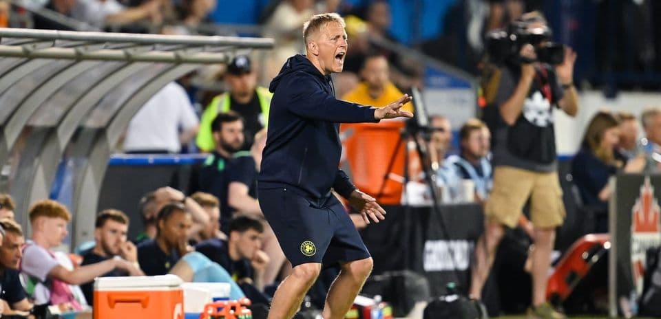 Coach gesturing passionately from the sidelines