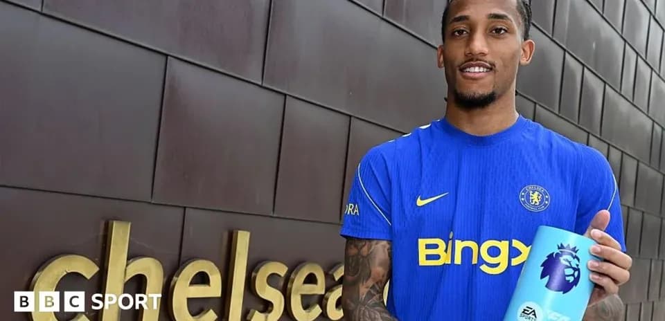 Player holding Premier League trophy outside Chelsea sign