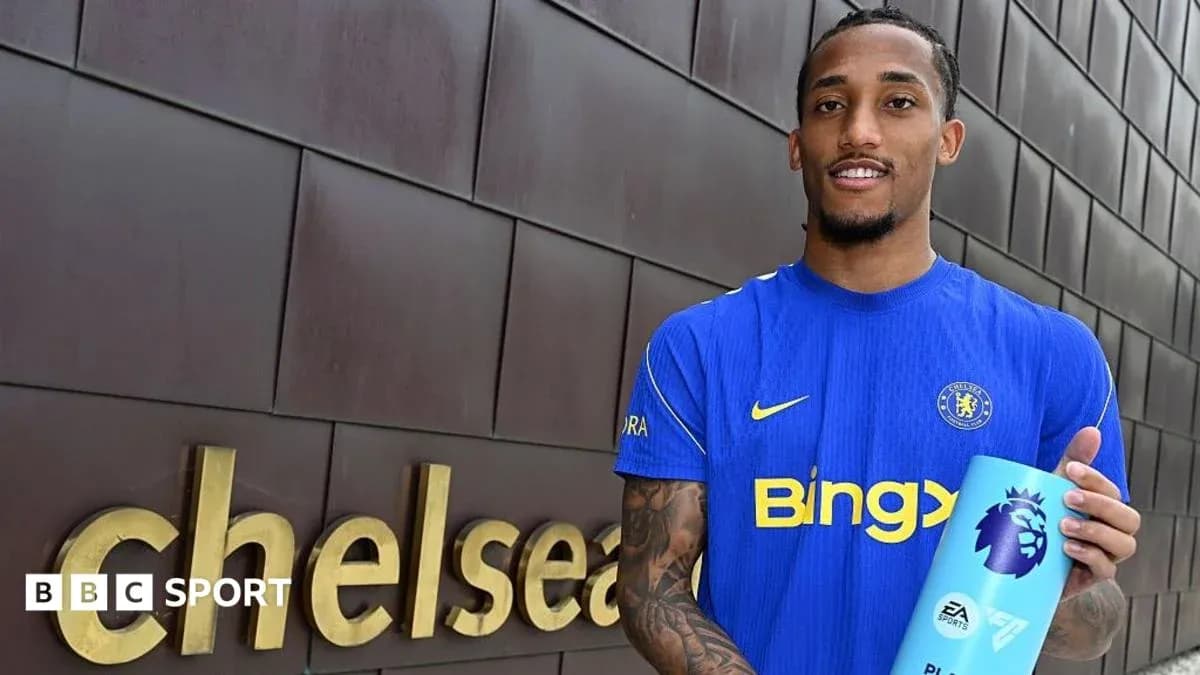 Player holding Premier League trophy outside Chelsea sign