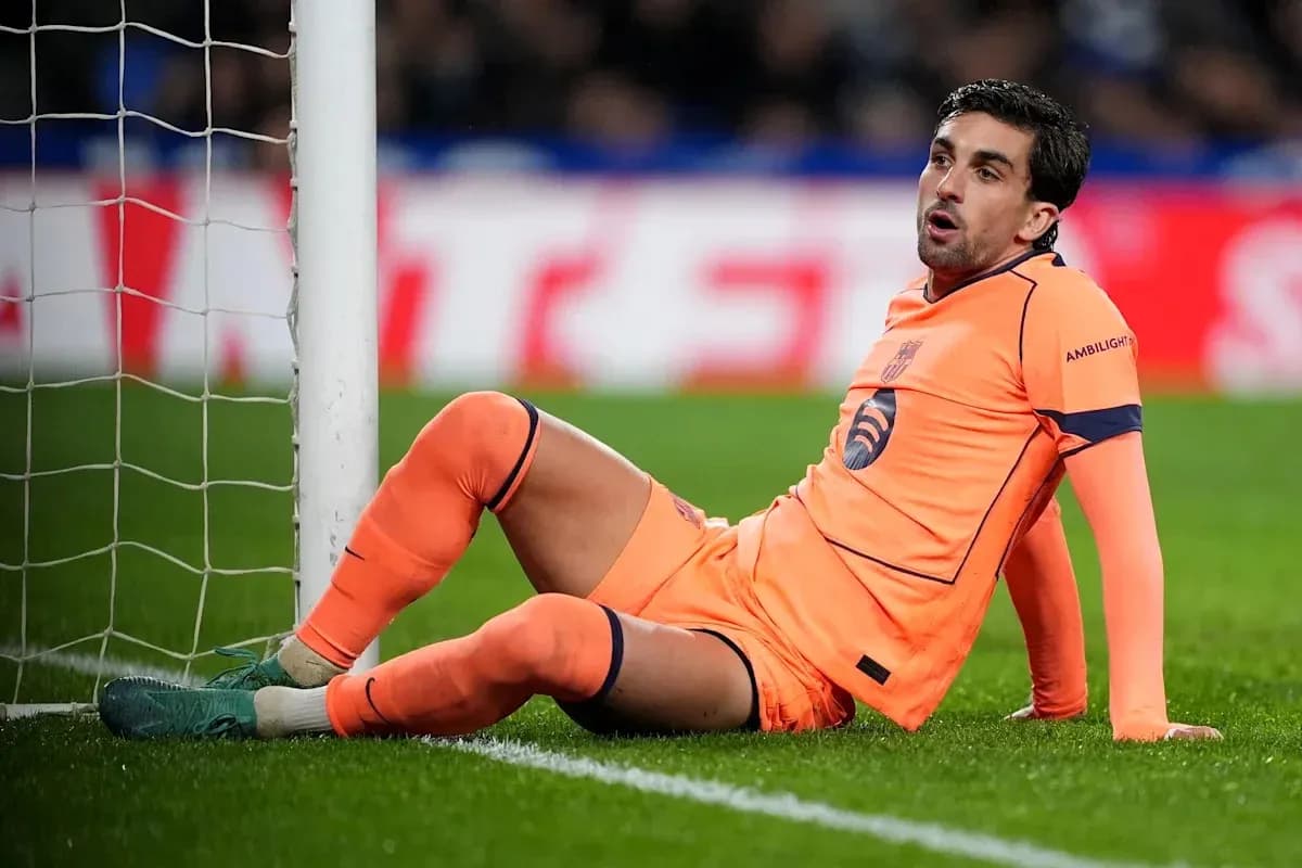 Goalkeeper sitting on the ground near goalpost