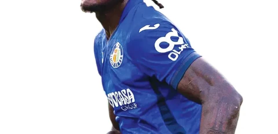 Player celebrating during a match in blue jersey