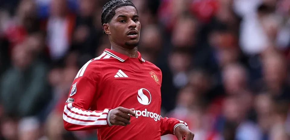Player in red Manchester United jersey on pitch