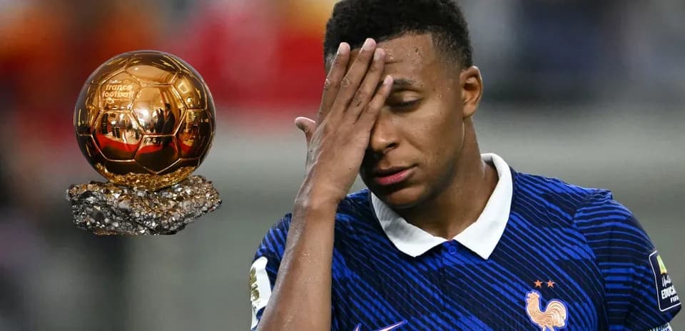 Player in France kit reacts near Ballon d'Or trophy