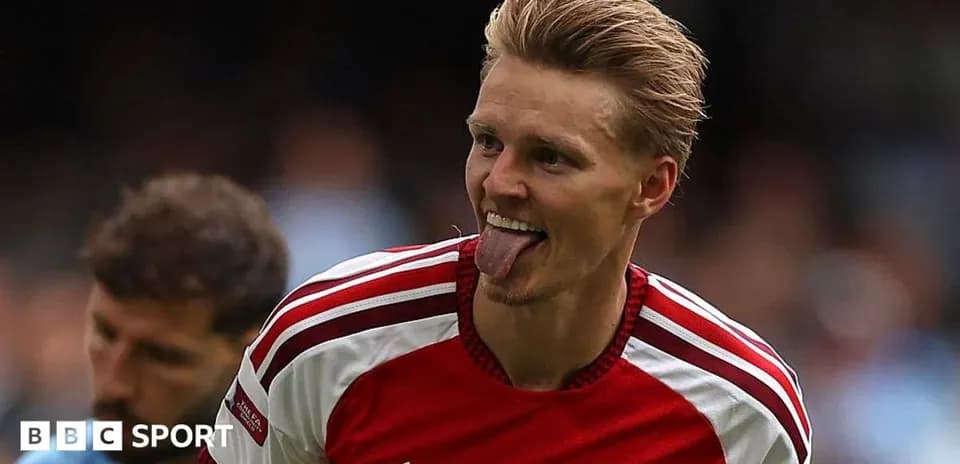 Arsenal player celebrating with tongue out during match