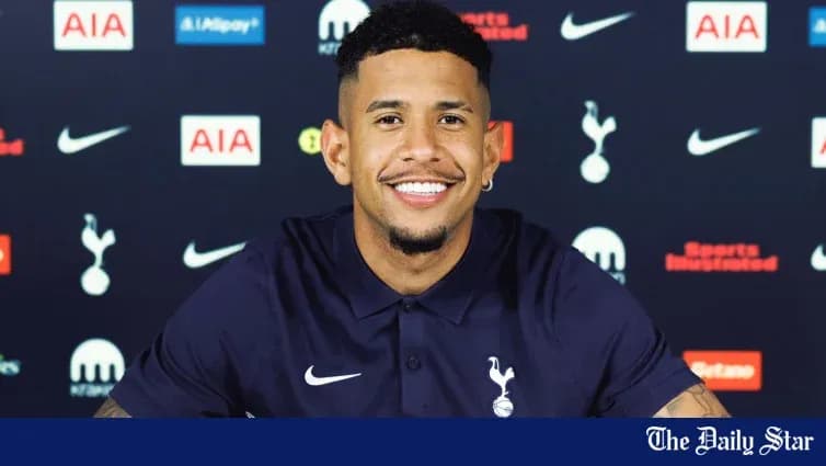 Player smiling during press conference at Tottenham