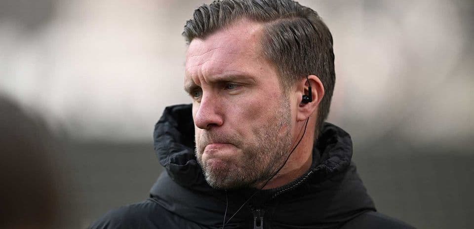 Coach listening intently during training session